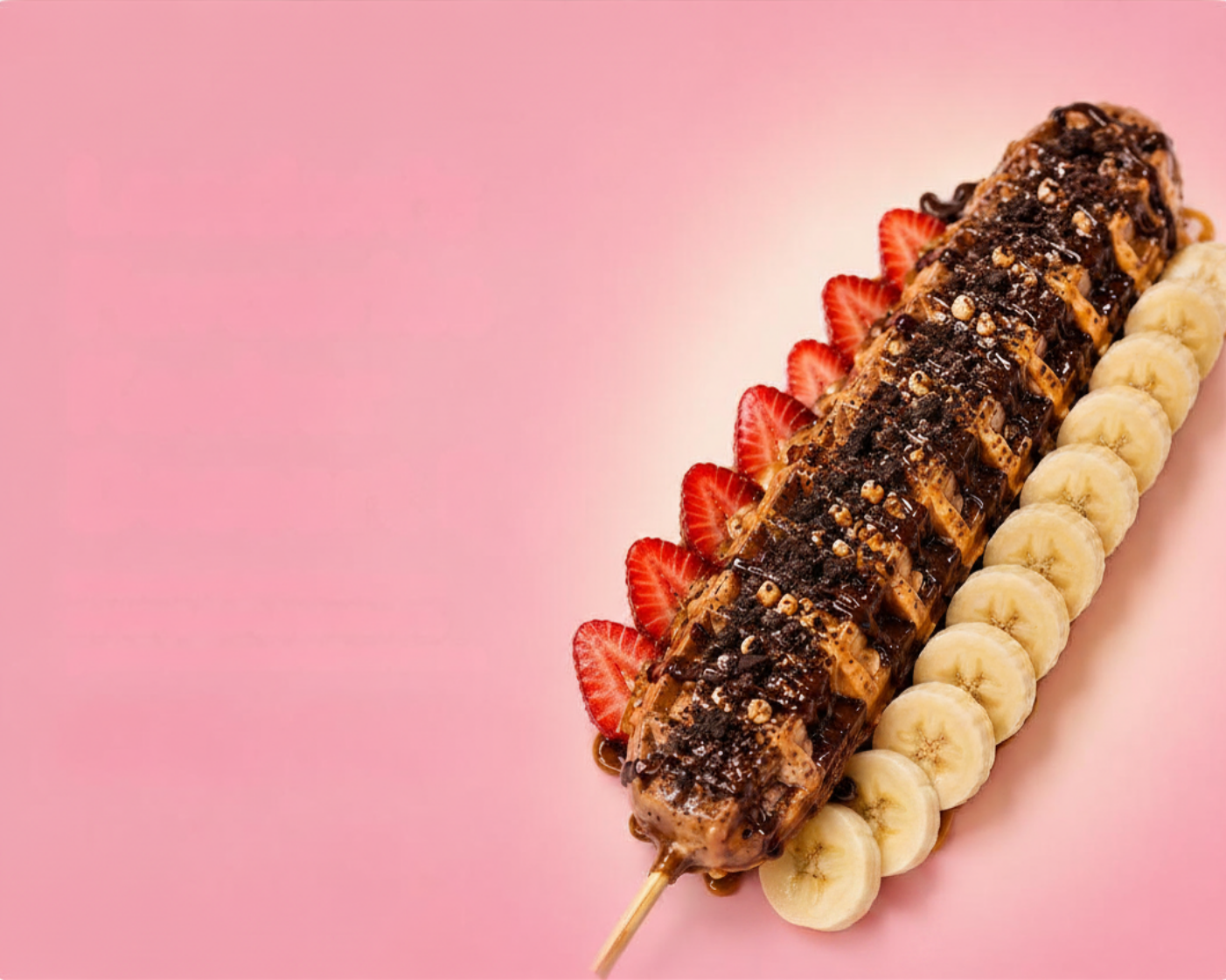 Wafflelicious waffle stick topped with chocolate, strawberries and banana